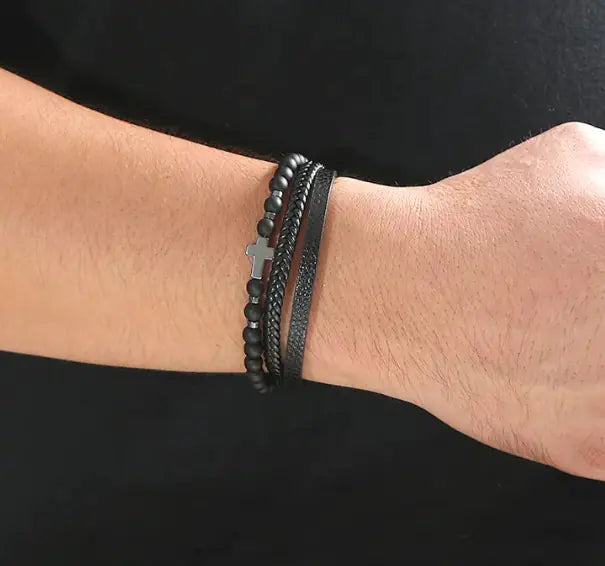 Men’s beaded and braided leather bracelet with silver cross charm – stylish and adjustable.